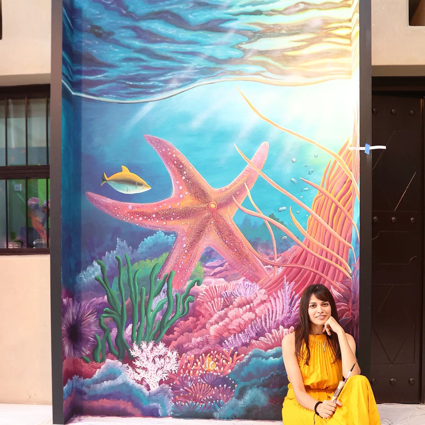 Snehita with her Mural painting " Under the Sea "
