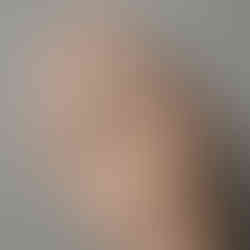 A hand wearing the "Lucid Dream" ring, showcasing its Gothic claw setting and raw textured band