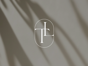 Stylized "TL" logo in white over shadowed gray background. Oval shape surrounds the text, creating an elegant, minimalist design.