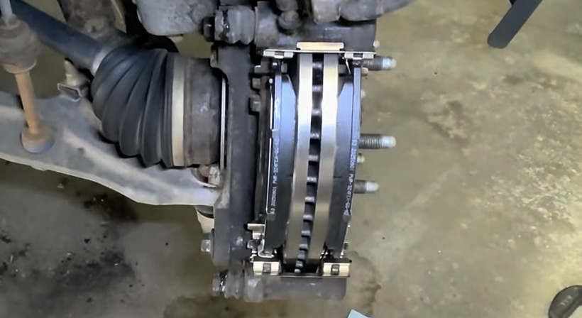 2015 Tahoe new front brake pads installed in caliper bracket