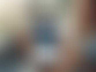 A parent's hand holding a smartphone displaying a beautifully optimized school website.