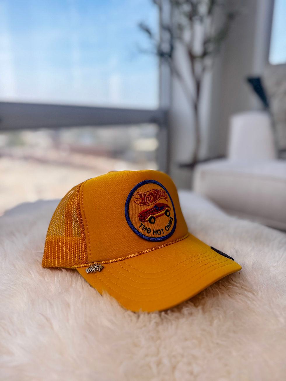 yellow mesh trucker hat featuring a Hot Wheels race car patch