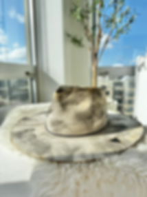 Greige felt rancher hat with smoky marbled finish, black rope chain band, and Swarovski triangle detail on the brim.