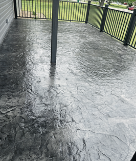 Charcoal textured concrete coating on a covered outdoor patio