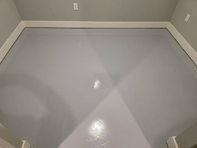 Interior room floor after solid gray epoxy coating — completed installation, Combs Custom Concrete