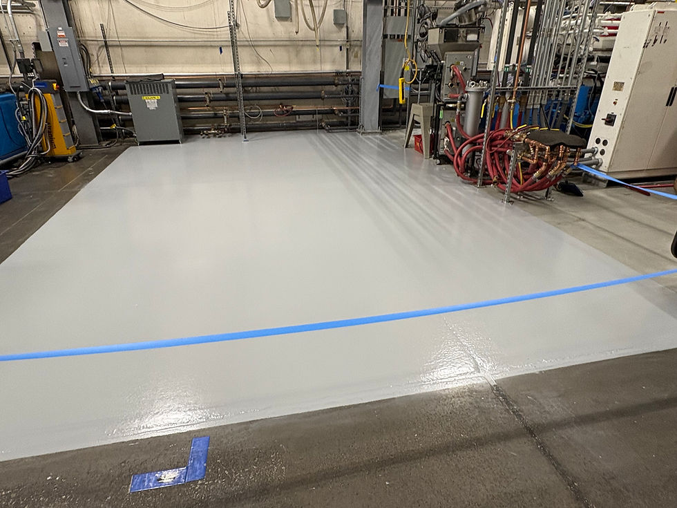 Commercial plastics warehouse floor after solid color epoxy coating — second angle finished result, Combs Custom Concrete