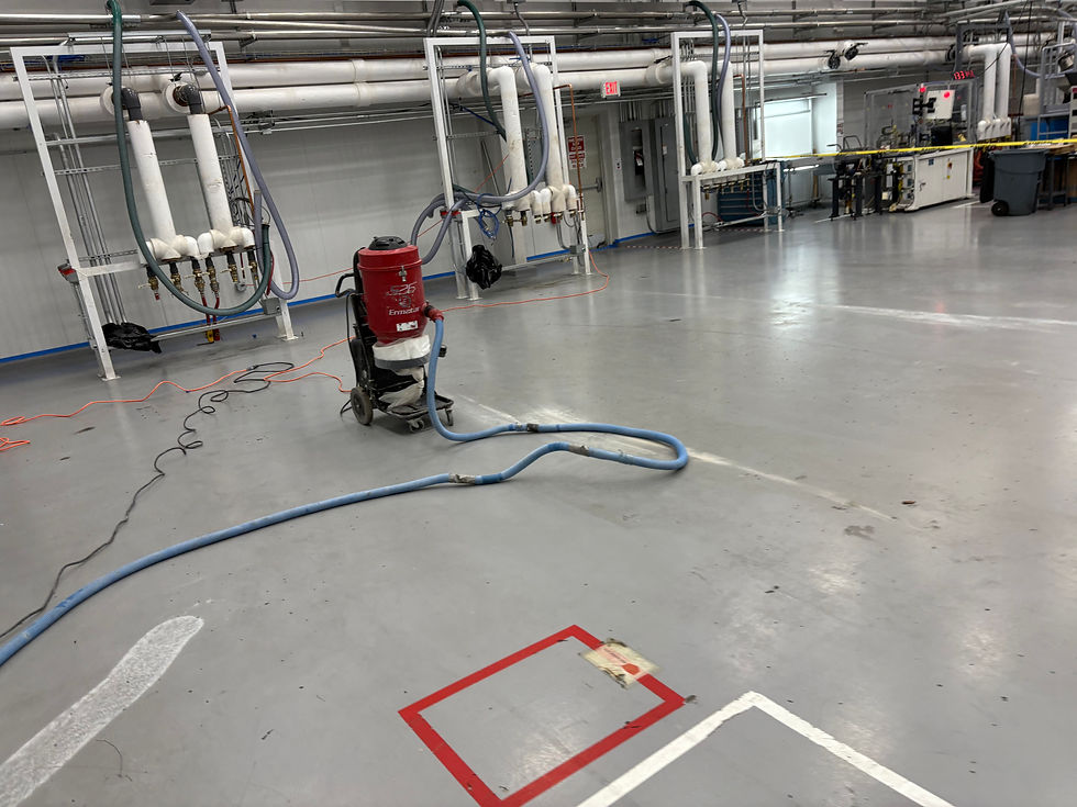 Commercial plastics warehouse floor before solid color epoxy coating — first angle, Combs Custom Concrete