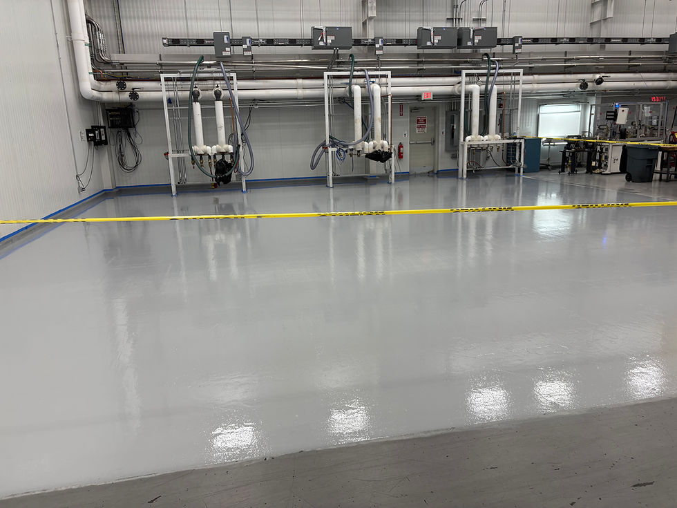 Commercial plastics warehouse floor after solid color epoxy coating — first angle, Combs Custom Concrete