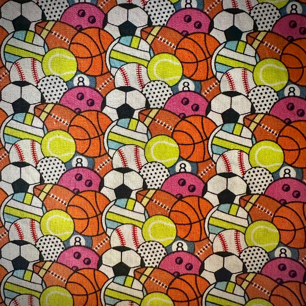 Gray cotton fabric featuring colorful sports balls used for the Sportzball handmade slip-on dog bandana by Gingersnappy.