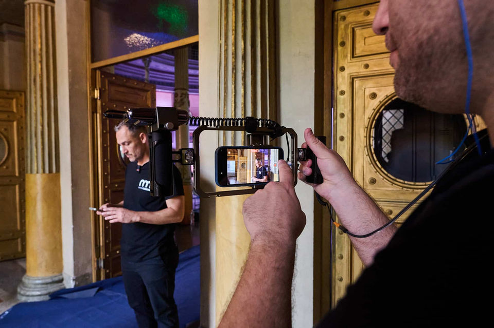 Event production – Technician adjusting cameras and sound at a corporate event.