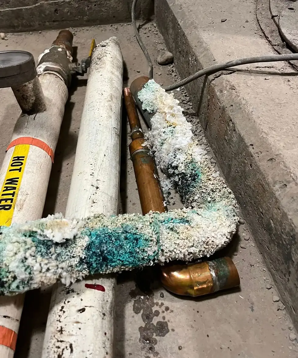 Corroded piping and saturated insulation showing the impact of long-term commercial HVAC system neglect.