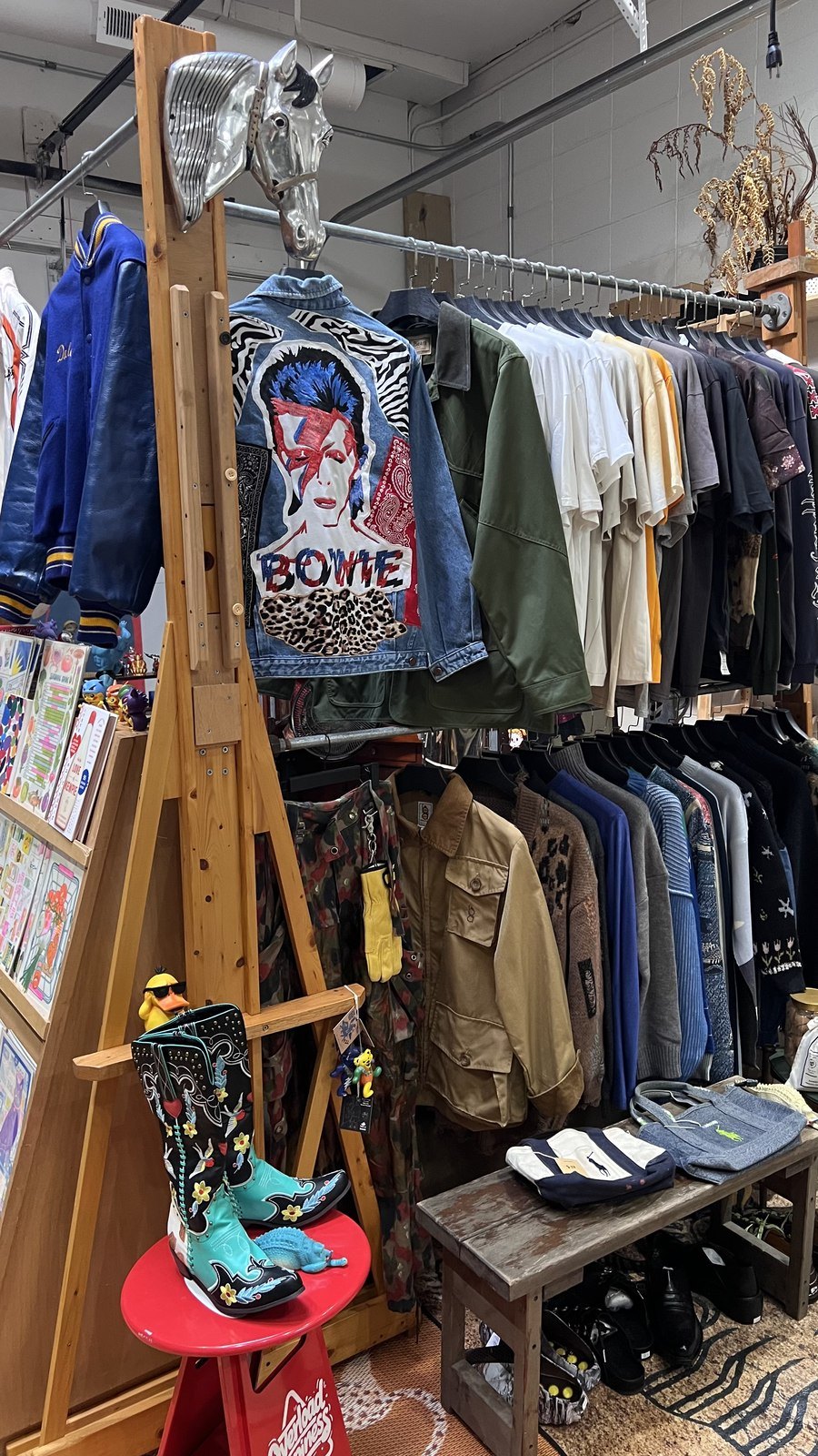 A first look at Ge’s Vintage: a Bowie collage jacket, clothing racks and a metal horse-head display.
