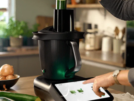 Thermomix TM7 with the Cutter+ attachment slicing vegetables on a kitchen bench