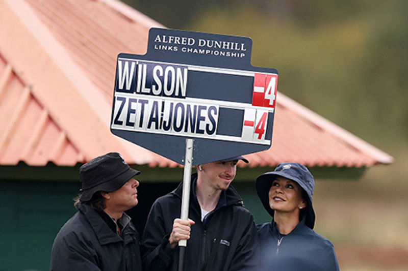 Source: Alfred Dunhill Links Championship (2025). Catherine Zeta-Jones with her scoreboard carrier.