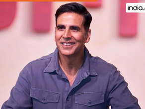 Smiling man in a red shirt against a gray background. The mood is cheerful and positive with no visible text.