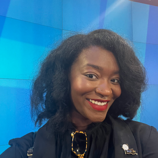 Image of Teryn with a black blazer and "the Tracee" hairstyle.