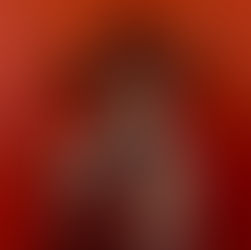 Image is of Teryn in a leopard print jumper in front of a red wall.