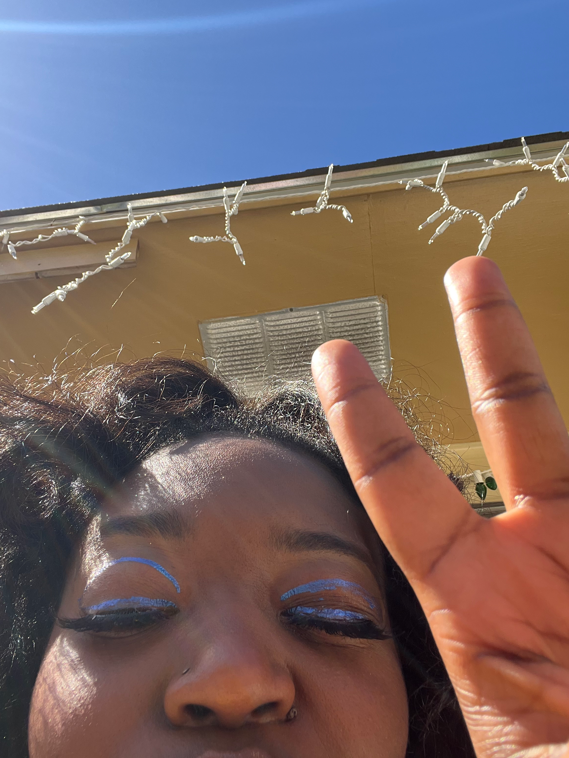Image is of Teryn with blue graphic eyeliner.