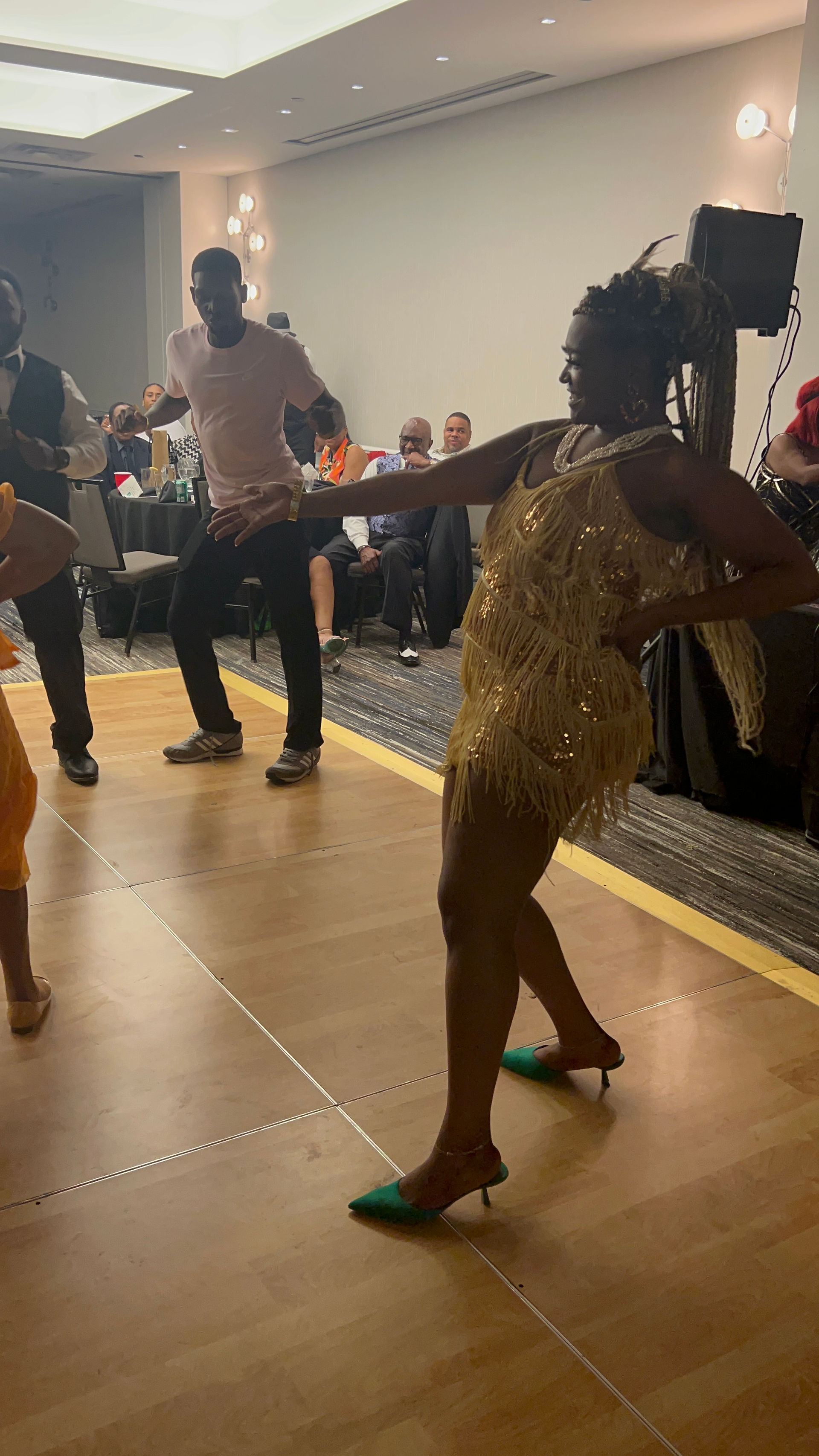 Image of Teryn in a gold flapper dress. 