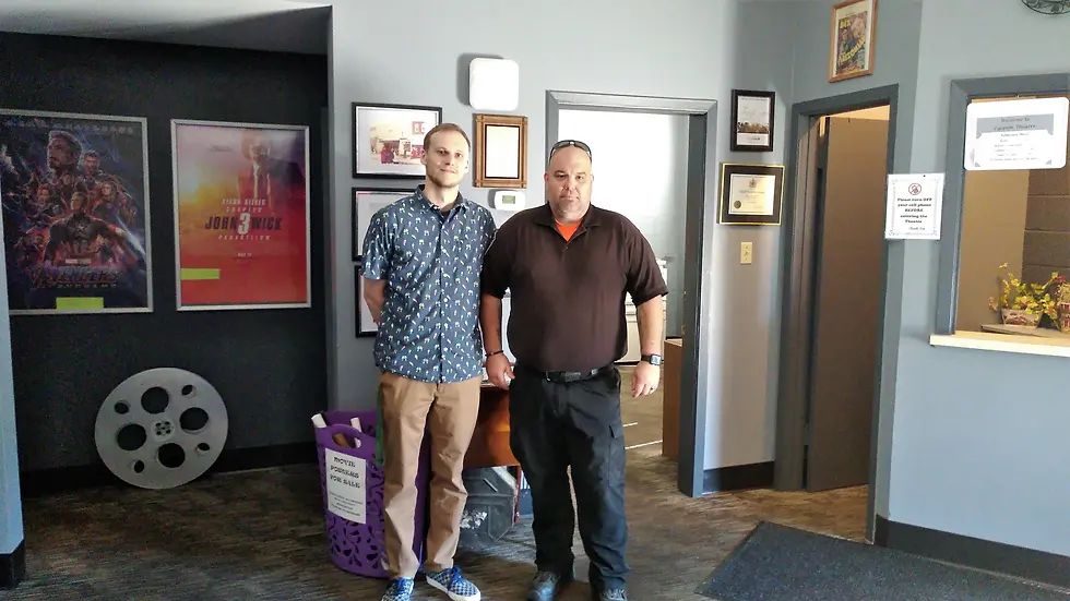 Above: Cole Girodat stands with Roy Krogsgaard, who ran the theatre while they looked for a new manager. Roy hands the torch off to Cole as he arrives for his first day.
