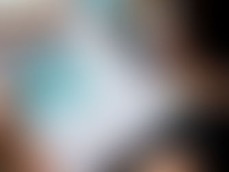 Person reviewing documents with a blue payment voucher, using a calculator on a desk. Papers, folders, and a pen are present.