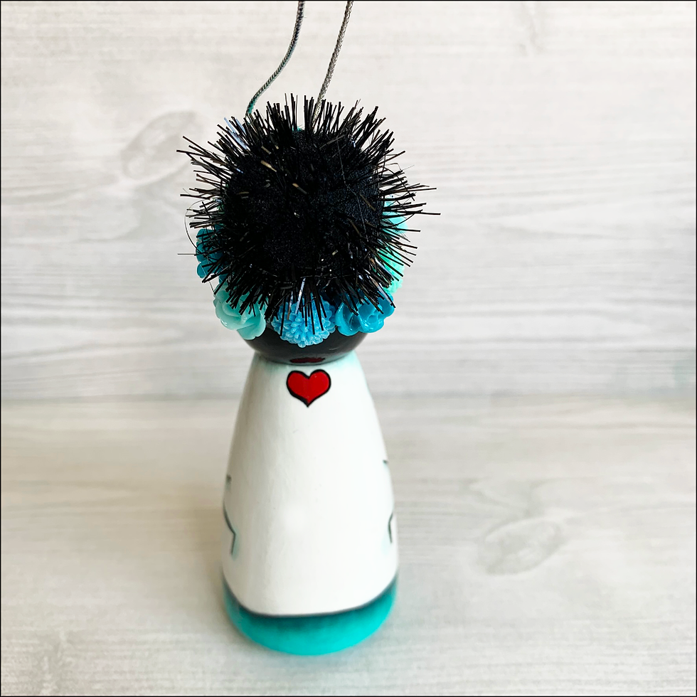Thumbnail: Frida in Turquoise Scrubs and Heart Mask Holding Heart Ornament