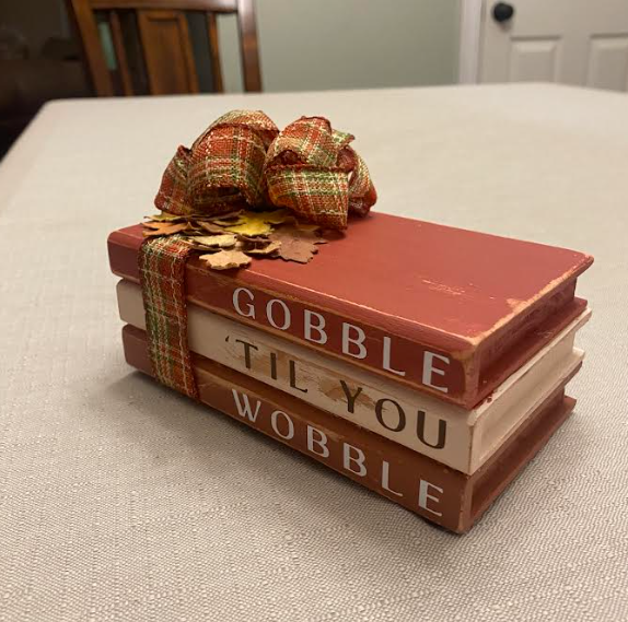 Thumbnail: Gobble Til You Wobble handmade home decor book stack