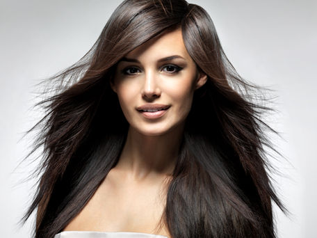 Young lady showing her long, shiny and healthy hair.