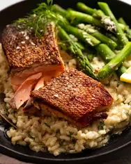 Crispy-Skin-Salmon-on-plate-with-creamy-risotto.webp