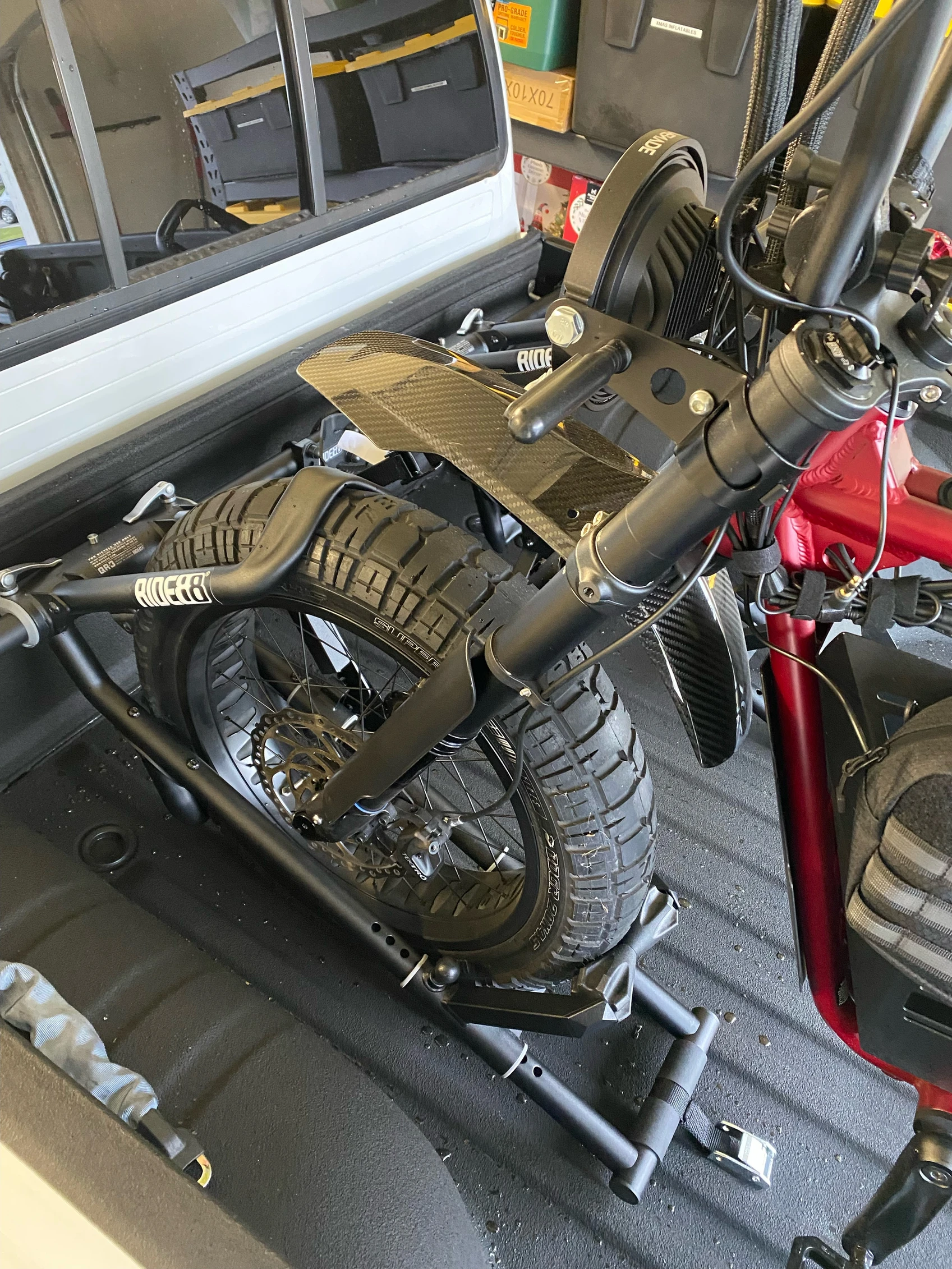 RIDE88 truck bike rack installed in a pickup truck holding a fat tire bike.