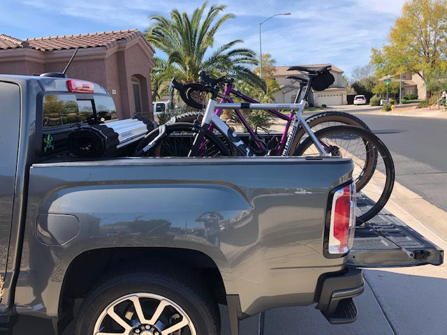Two RIDE88 truck bike racks installed in a pickup truck holding two road bikes.