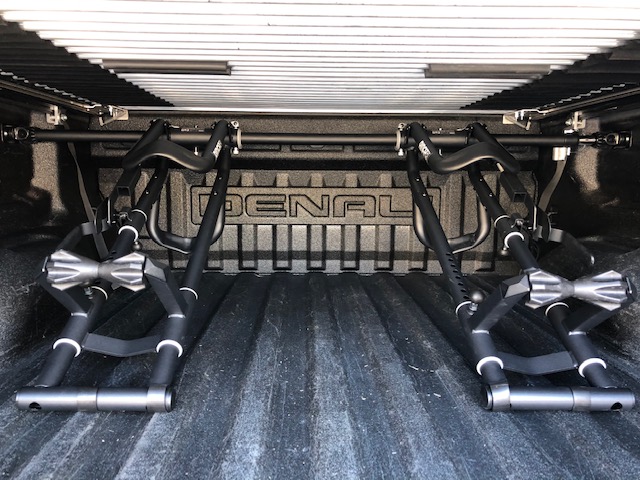 Two RIDE88 truck bike racks installed on a pickup truck folded downward to be compatible with a tonneau cover.