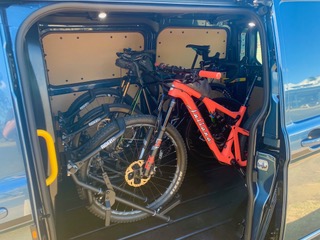 Bikes loaded in Ride88 bike racks installed inside a van