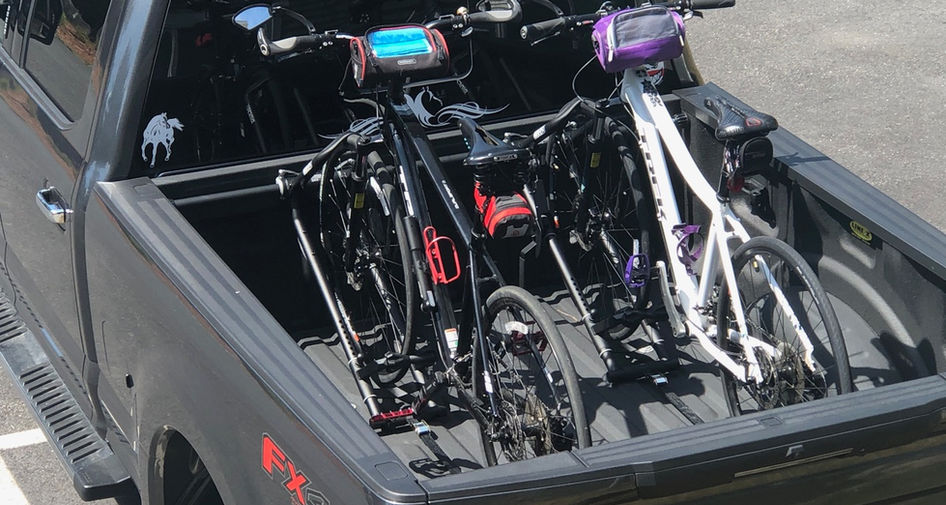 Two RIDE88 QR3 Truck Bed Bike Racks installed in a truck bed with mountain bikes mounted.