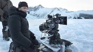 Film crew in warm coats on an icy set. The film camera is freezing over.