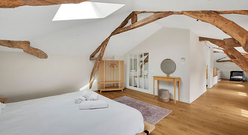 Elegant attic bedroom in a high-end wedding accommodation in the Tarn