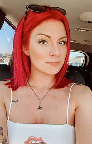 A girl in a white dress with short hair showcasing a fusion of red hair colors