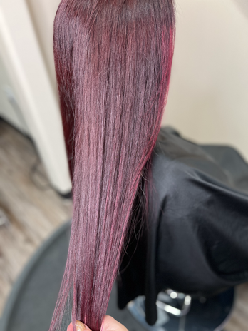 A girl with long, vibrant red hair flowing down her back