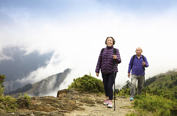 older-couple-hiking-walking-nordic-Tomwa