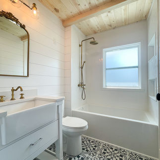 Wood ceiling and farm house sink cozy bathroom