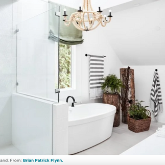 White bathroom renovation with a statement light fixture