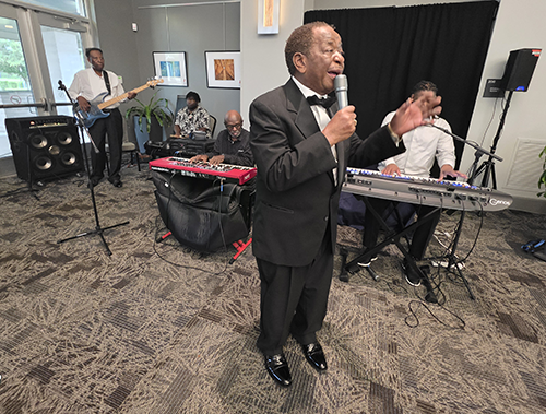 Singer in front of band.png