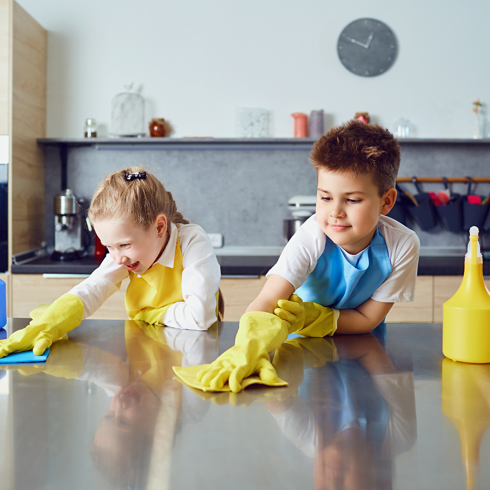 Hero image of two children cleaning kitchen as part of Bluebird Design Company blog on how to get kids excited about helping with household chores.