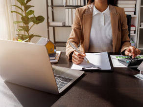 woman at desk trying to calculate her mortgage costs