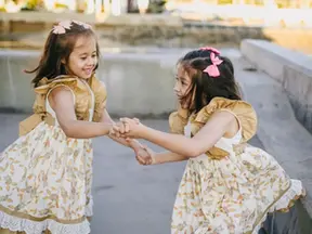 Twin girls holding hands