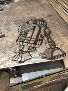 Thumbnail: A metal sign of R2D2 from Star Wars