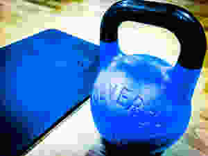 Wolverson Fitness kettlebell, and exercise mat being used during home workout.