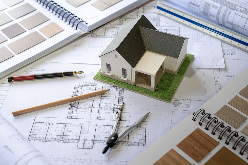 Close-up view of blueprint plans with measuring tape