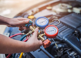 auto-mechanic-worker-hands-holding-monitor-to-check-and-fix-car-air-conditioner-system-in-car-garage.jpg