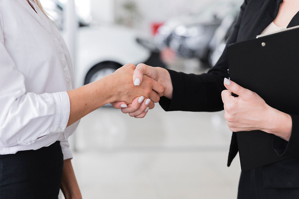 women-shaking-hands-car-show-room.jpg